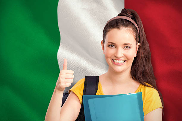 Student with thumbs up against digitally generated italian national flag